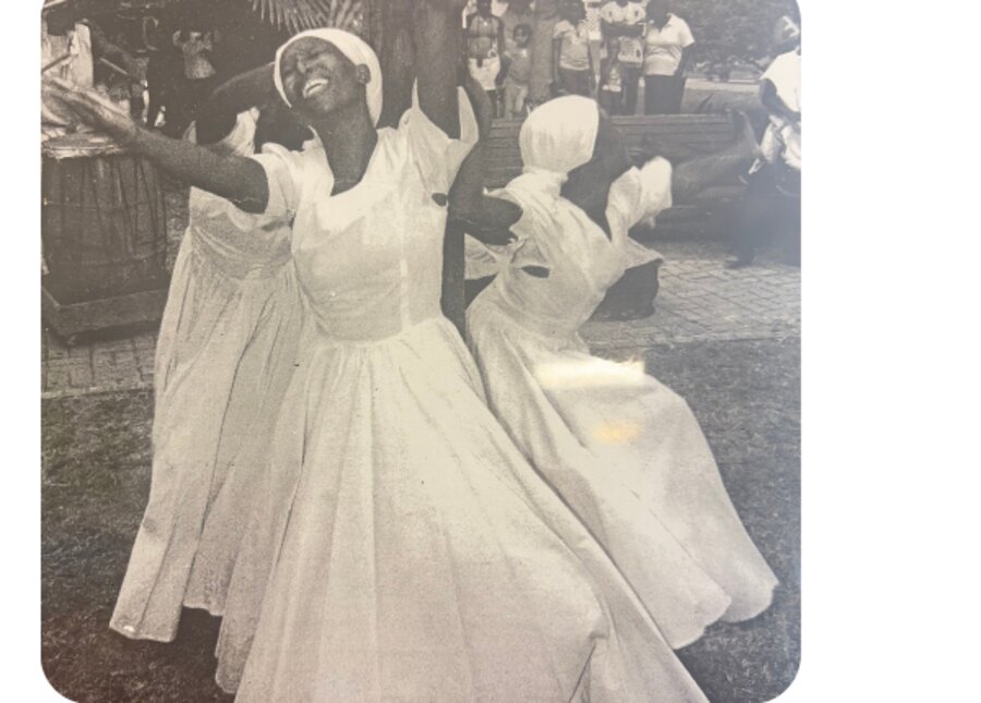 Black-and-white archival photograph of Virgin Islands quadrille dancers in flowing white dresses performing outdoors.